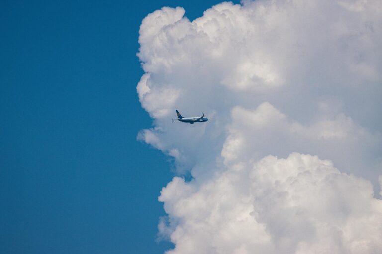 airplane soaring amidst dramatic clouds